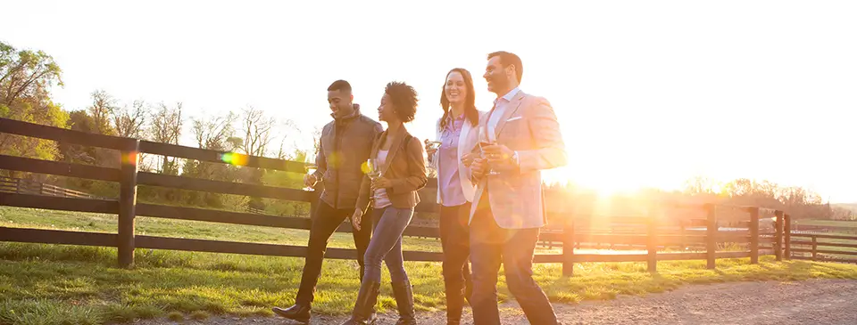 Two couples enjoying a sunset walk at a resort