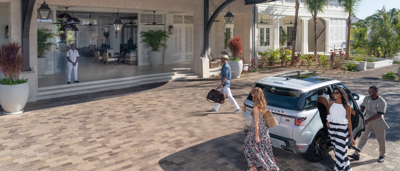 People arriving at the entrance to a resort